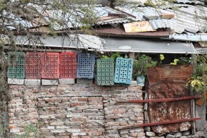 Building (and innovating) with what's available. Plastic crates. Tin sheets. Repurposed iron. Bricks. 